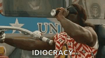 A Man Is Riding A Motorcycle And Holding A Can Of Soda In His Hand . GIF