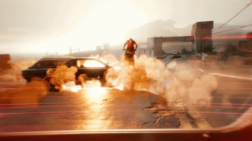 A Man Is Riding A Motorcycle On A Street With Smoke Coming Out Of It GIF
