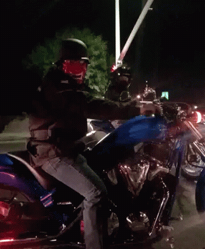 A Man Is Riding A Motorcycle With A Blue Tank GIF