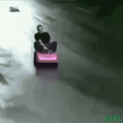 A Man Is Riding A Pink Lawn Mower With The Word Drift On The Bottom GIF