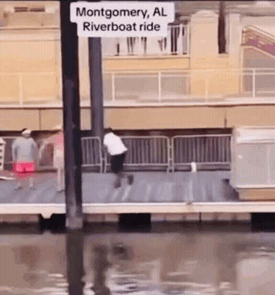 A Man Is Riding A Riverboat In Montgomery Al . GIF