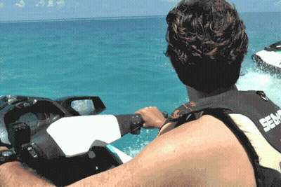 A Man Is Riding A Sea Doo Jet Ski In The Water GIF