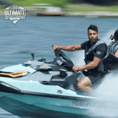 A Man Is Riding A Sea Doo Jet Ski In The Water With The Ultimate Challenge Logo Behind Him GIF