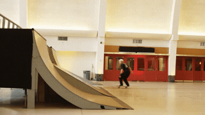 A Man Is Riding A Skateboard Down A Ramp GIF