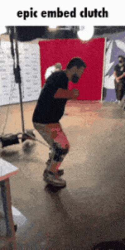 A Man Is Riding A Skateboard In Front Of A Red Backdrop With The Caption Epic Embedded Clutch GIF