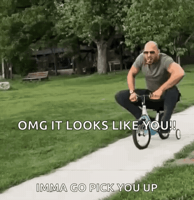 A Man Is Riding A Small Bicycle Down A Sidewalk . GIF