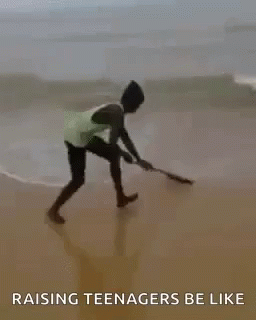 A Man Is Riding A Wave On A Surfboard On The Beach With The Words `` Raising Teenagers Be Like '' . GIF