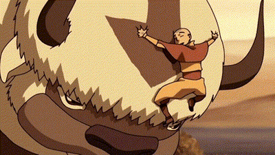 A Man Is Riding On The Back Of A Bison With Horns . GIF