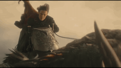 A Man Is Riding On The Back Of A Dragon With A Sword . GIF