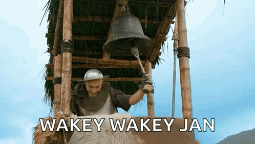 A Man Is Ringing A Bell With The Words Wakey Wakey Jan Written On The Bottom GIF