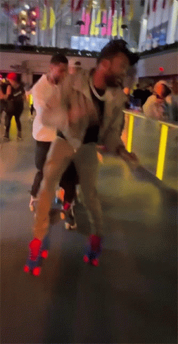 A Man Is Rollerblading On A Rink With A Crowd Behind Him GIF