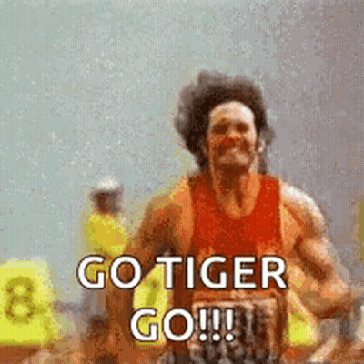 A Man Is Running On A Track With The Words `` Go Tiger Go '' Written On It . GIF