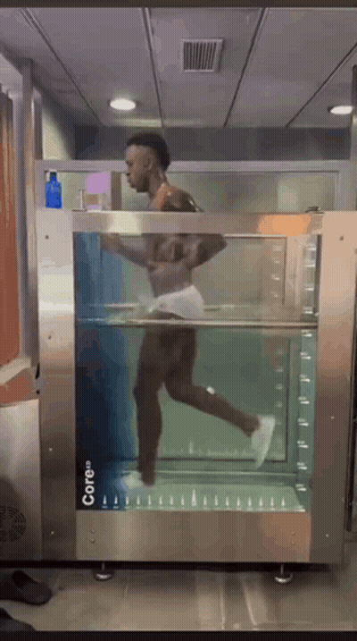 A Man Is Running Through A Machine That Says Core On It GIF