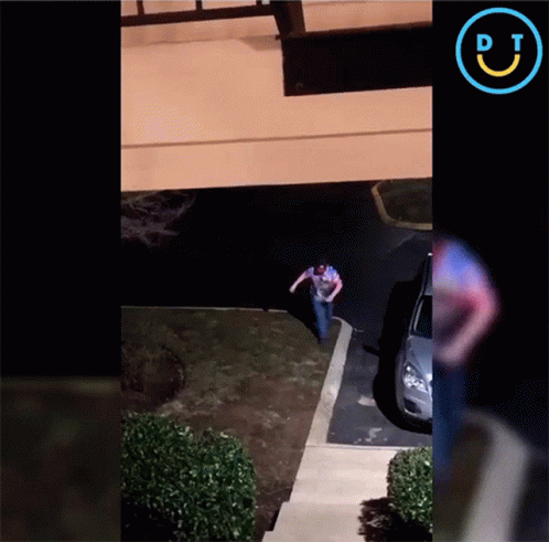 A Man Is Running Towards A Car In A Parking Lot With A Pj Logo GIF