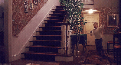 A Man Is Running Up A Set Of Stairs In A Home GIF