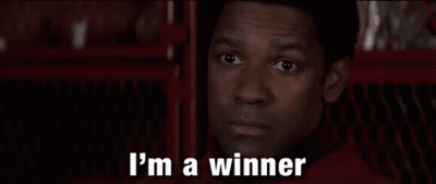 A Man Is Saying `` I 'M Going To Win '' While Standing In Front Of A Red Fence . GIF