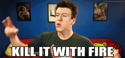 A Man Is Saying Kill It With Fire In A Room With Pictures On The Wall GIF