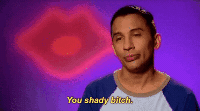 A Man Is Saying You Shady Bitch In Front Of A Pink Heart . GIF
