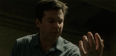 A Man Is Screaming And Holding His Hands Up With The Word Blood Written Next To Him . GIF