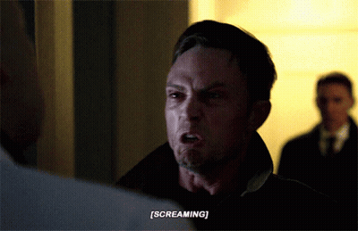A Man Is Screaming While Another Man Watches GIF