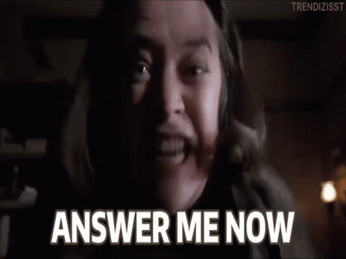 A Man Is Screaming With His Mouth Open And The Words `` Answer Me Now '' Written On The Screen . GIF