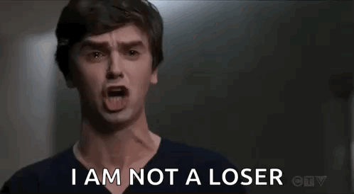 A Man Is Screaming With His Mouth Open And The Words `` I Am Not A Loser '' . GIF
