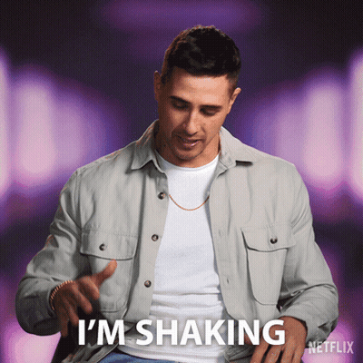 A Man Is Shaking His Shirt And Says I 'M Shaking On A Purple Background GIF