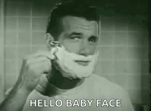 A Man Is Shaving His Face With A Razor In A Bathroom And Says `` Hello Baby Face '' . GIF