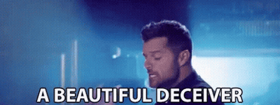 A Man Is Singing A Song And The Words A Beautiful Deceiver Are Next To Him GIF