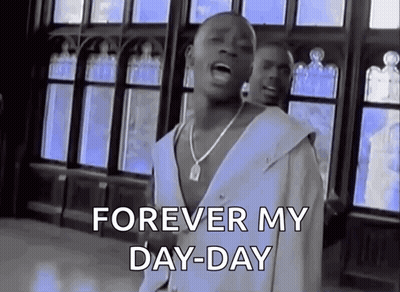 A Man Is Singing A Song In Front Of A Window While Wearing A White Shirt And A Necklace . GIF