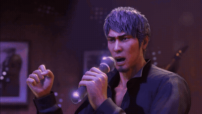 A Man Is Singing Into A Microphone In A Dark Room GIF