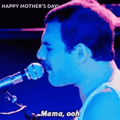A Man Is Singing Into A Microphone With The Words `` Mama Ooh '' . GIF