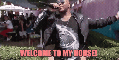A Man Is Singing Into A Microphone With The Words Welcome To My House Written Below Him GIF