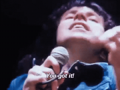 A Man Is Singing Into A Microphone With The Words `` You Got It '' . GIF