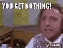 A Man Is Sitting At A Desk And Making A Funny Face . GIF