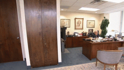 A Man Is Sitting At A Desk In An Office GIF