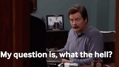 A Man Is Sitting At A Desk In An Office Talking To A Woman And Saying `` My Question Is , What The Hell ? '' GIF