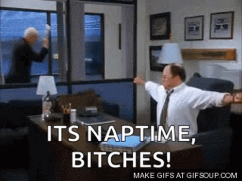 A Man Is Sitting At A Desk In An Office With His Arms Outstretched And Says It 'S Naptime Bitches . GIF
