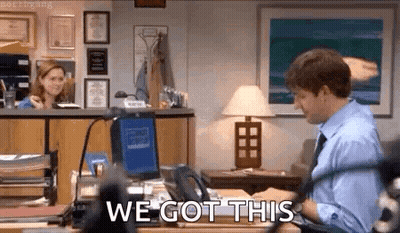 A Man Is Sitting At A Desk In Front Of A Computer With The Words `` We Got This '' Written On The Screen . GIF