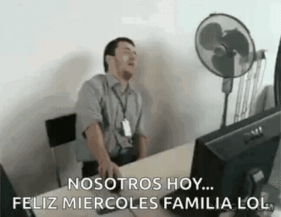 A Man Is Sitting At A Desk In Front Of A Computer Yawning . GIF
