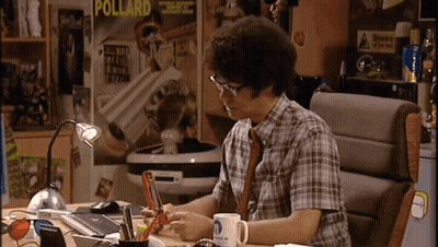 A Man Is Sitting At A Desk In Front Of A Poster That Says Pollard On It GIF