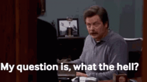 A Man Is Sitting At A Desk Talking To A Woman And Says `` My Question Is What The Hell ? '' GIF
