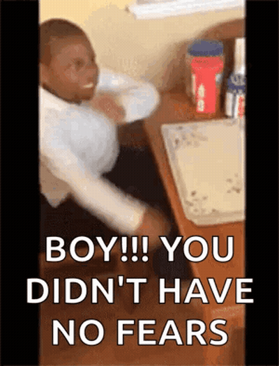 A Man Is Sitting At A Desk With A Box Of Peanut Butter On It . GIF