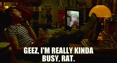 A Man Is Sitting At A Desk With His Feet Up And Talking On A Phone . GIF