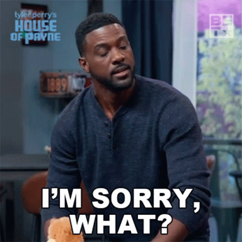 A Man Is Sitting At A Table And Saying I 'M Sorry , What ? GIF