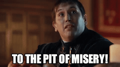 A Man Is Sitting At A Table And Says `` To The Pit Of Misery '' . GIF