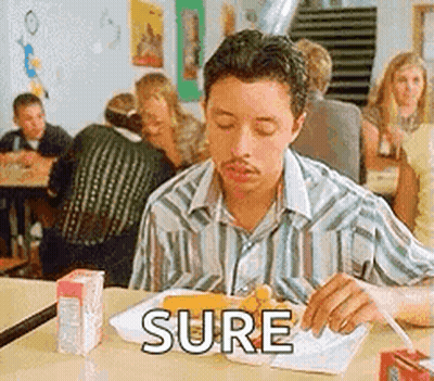 A Man Is Sitting At A Table Eating A Meal With The Word Sure Written On The Table . GIF