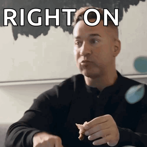 A Man Is Sitting At A Table Eating A Piece Of Food With The Words Right On Above Him GIF