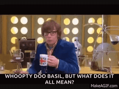 A Man Is Sitting At A Table Holding A Cup Of Coffee And Talking . GIF
