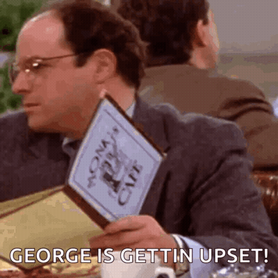 A Man Is Sitting At A Table Holding A Menu And Saying `` George Is Gettin Upset ! '' GIF